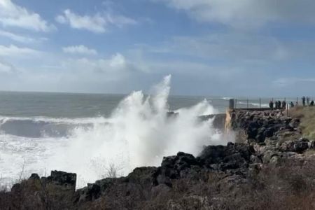 An image of a stormy sea with waves crashing into land, representing complaining is a stress response
